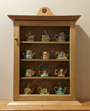 Load image into Gallery viewer, maple curio cabinet front view with ornamental teapots shaker design framed glass door dovetailed