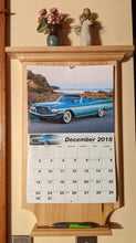 Load image into Gallery viewer, maple calendar holder front view with calendar and picture pen on holder and knickknacks on top shelf