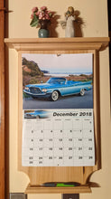 Load image into Gallery viewer, maple calendar holder front view with calendar and picture pen on holder and knickknacks on top shelf
